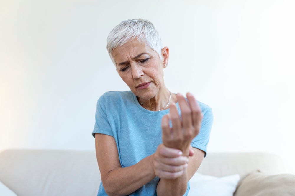 Dr Dharshen Naicker examining a patient's hand for signs of arthritis