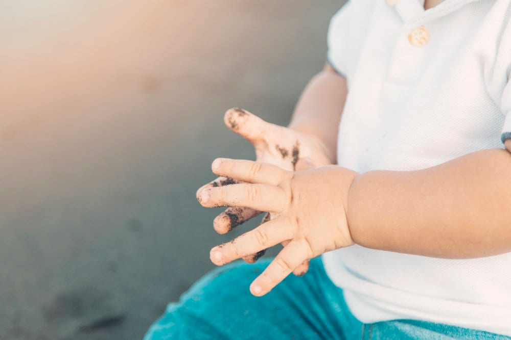 Dr Dharshen Naicker examining a young patient's hand