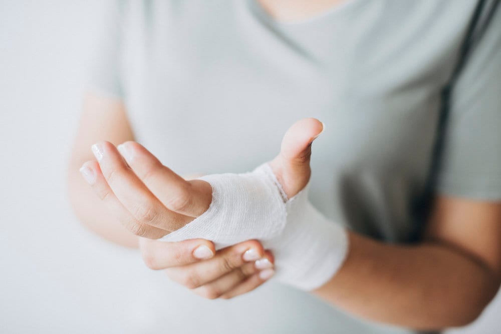 Dr Dharshen Naicker assessing a patient's wrist injury